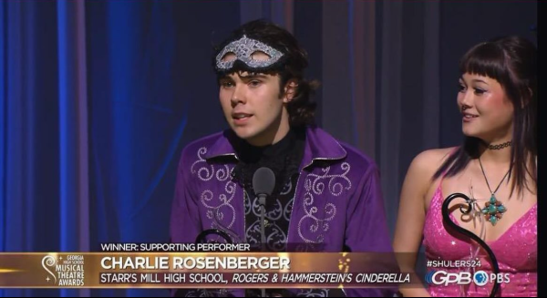Senior Charlie Rosenberger collects his Shuler for best supporting performance in the Starr’s Mill Theatre Department’s production of “Cinderella.” Senior Emily Steele and Rosenberger also won a Shuler for best costume design. This is the second year in a row that the Starr’s Mill Theatre Department brought home at least one Shuler. 